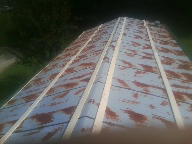 Rusted metal roof panels with new wood purlins before replacement — Storm Damage Roof Repair in Clayville by Roofing Brothers