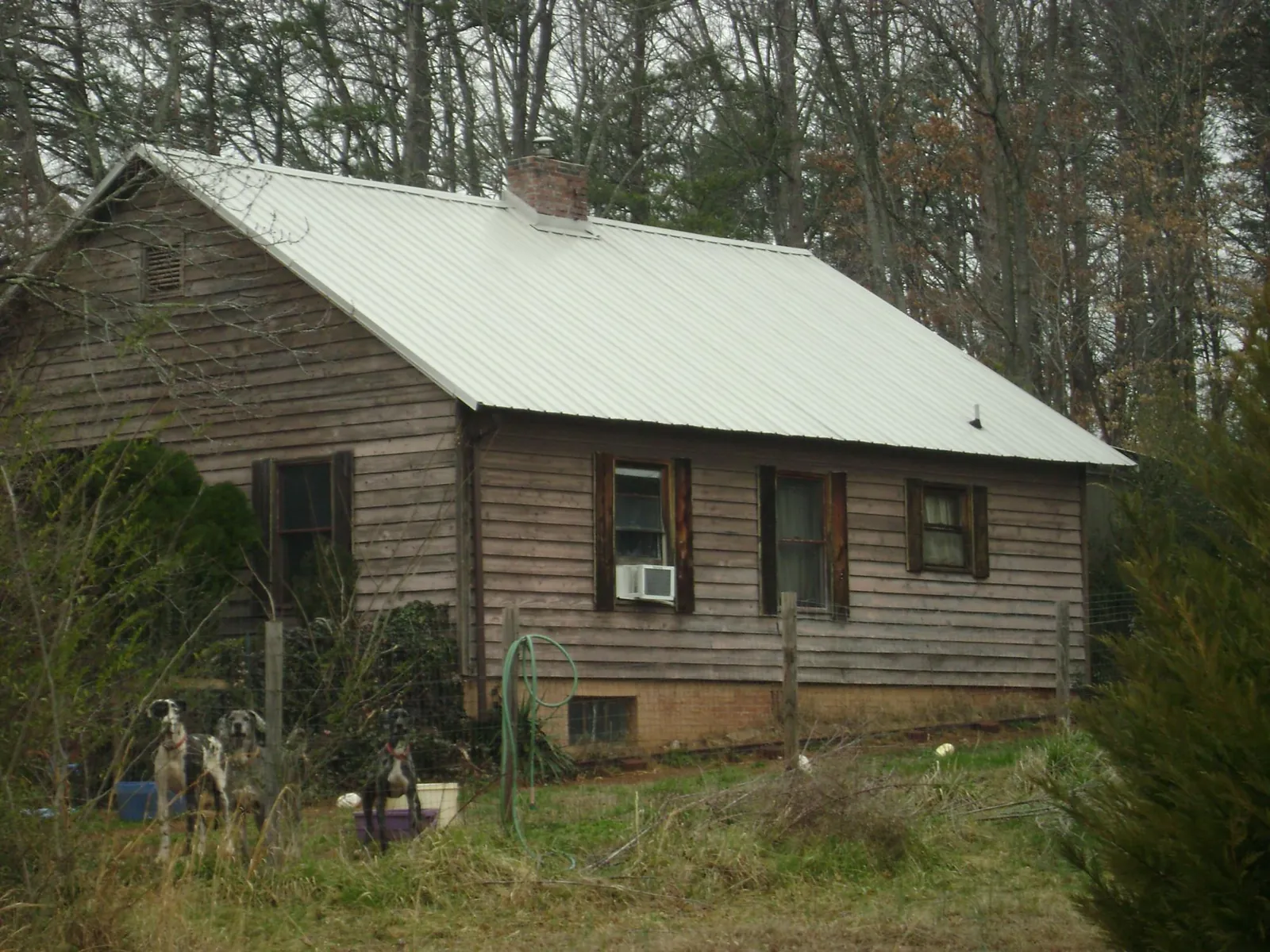 White metal roof on an old wood sided farmhouse, from a Metal Roof Installation job in Clayville